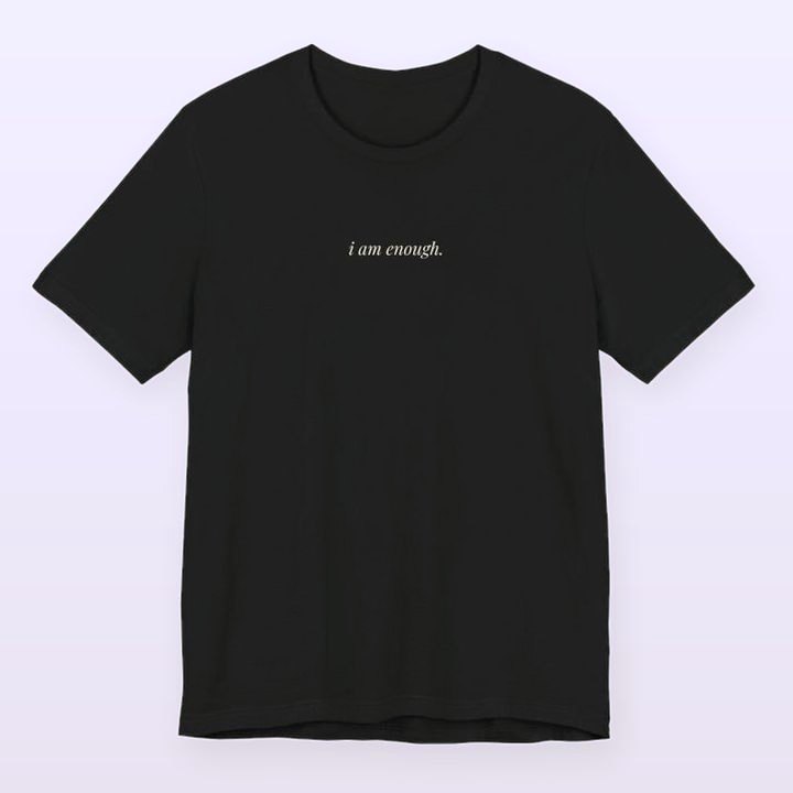 black cotton t-shirt printed with the words: i am enough